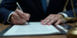 © budistwn - Justice and law concept. Gavel on sounding block in hand's Male judge at a courtroom, working with document law books, report the case on table in modern office.