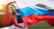 © Vladimir Razgulyaev - Woman celebrating Russia Day while waving the Russian flag during her travel trip. A woman in a red jacket celebrates Russia Independence Day