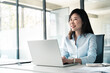 © Stock 4 You - Thoughtful 30s middle-aged woman using computer for financial bank work online. Mature Asian professional specialist businesswoman working on laptop pc sitting at desk in office looking dreaming aside