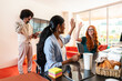 © oneinchpunch - Multiethnic small group of businesspeople meeting in a coworking company office