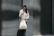 © 4Max - Woman walking in the city with a white tote eco bag