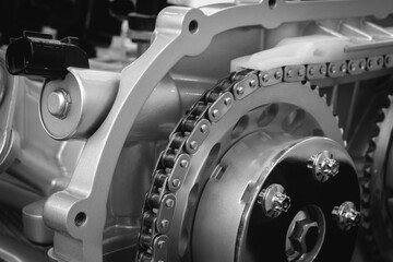 Aufkleber - A close up of a chain drive engine. The chain is silver and has many small holes auto service concept background