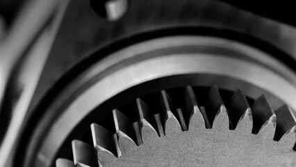 Poster - A close up of a gear with a black and white filter. Concept of precision and complexity, as gears are often used in machinery and other mechanical systems. black and white filter adds a timeless