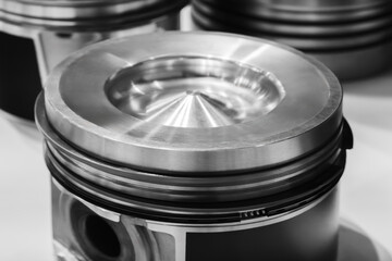 Aufkleber - A close up of a piston with a cone shaped top. The piston is silver and has a black rim auto service concept background