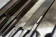 © Yevhenii - Collection of old flat and round rasps or files. Various rough work surfaces