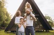 © anatoliycherkas - Happy family posing in front of their modern a frame house