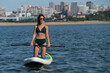 © Михаил Решетников - Caucasian woman riding a SUP board on the lake. Summer sport.