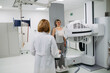 © Halfpoint - Doctor operating dynamic X-ray scan using tilting fluoroscopy unit