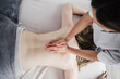 © Westend61 - Female physiotherapist massaging patient in hospital
