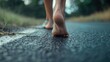 © Cherkasova Alie - Walking barefoot on an asphalt road.