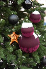 Wall Mural - snowy christmas tree with big balls and wooden star decoration, evergreen and snow, close-up, mockup