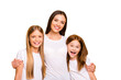 © deagreez - Two small ladies with young nanny hugging wear casual white t-shirts isolated yellow background
