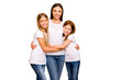 © deagreez - Two small ladies hugging young and beautiful babysitter wear casual white t-shirts isolated yellow background