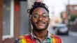 © Lazar - This vibrant portrait captures a smiling man wearing stylish glasses and a colorful outfit, set against an inviting urban backdrop that radiates confidence and positivity.