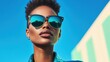© Lazar - A chic model showcases trendy sunglasses under a bright blue sky, capturing confidence, style, and the joy of sunny days in a vibrant fashion photography setting.