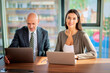 © gzorgz - Business people sitting at office desk and using laptops and discussing