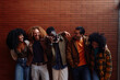 © bernardbodo - Group of diverse friends laughing together against brick wall