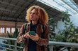 © bernardbodo - Young student using smart phone in train station, madrid