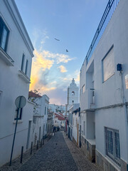 Naklejka na meble A charming Lagos scene features patterned tiles, pastel walls, and traditional Portuguese architecture glowing under the warm afternoon sun
