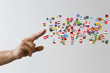 Aufkleber - Image of a hand reaching towards a scattering of world flags, symbolizing global connection and international relations.