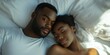 © MNStudio - Young loving couple cuddling in bed in the morning. Young man and woman hugging laying on white sheets. Husband and wife in love.