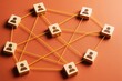 © Pixels Hunter - Wooden blocks with person icons connected by yellow strings on orange background showing communication network concept in light graphic style.