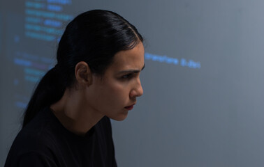 young hispanic female software developer working on computer for coding software program in office. 