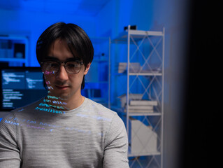 young male software developer working on desktop computer, write code program language with line of 