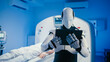 © ihorvsn - Futuristic humanoid robot holding tablet and analyzing patient medical data in high-tech diagnostic room. Robot standing in front of CT scanner while person lying motionless on examination bed.