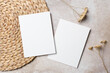 © nikavera - Two blank white vertical wedding invitation cards, front and back sides on beige background with dried flowers and woven placemat. Boho style flat lay with copy space