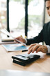 © Dino - Close-up of hands working with computer tablet in modern office. Preparing accounting analysis report, real estate investment information, financial and tax system concept.
