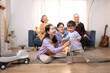 © Wosunan - Happy multi-generational Asian family enjoying quality time together at home
