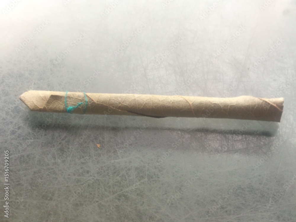 Selective focus of Indian desi cigarette or beedi. Bidi or beedi is indian  old version of cigarettes. Which made by dried leaves and tobacco. Also  known as beedi, bidi, handmade cigarette Stock