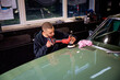 © sepy - Young man using professional buffer tool to polish car