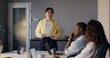 © m-art - Meeting in a modern office. A woman speaks while standing in front of her colleagues with documents in her hands