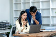 © Wicitr - Business Colleagues Collaborating on Laptop in Office