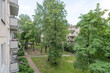 © Mindaugas Dulinskas - View of Green Courtyard from Residential Building Balconies on a Calm Day
