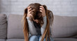 © Prostock-studio - Desperate young woman sitting head in hands on sofa and crying, panorama. Upset lady thinking about problem or having depression, suffering from nervous breakdown. Mental health concept
