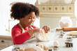© Prostock-studio - Adorable Little Black Girl Kneading Dough For Cookies, Having Fun In Kitchen Interior. Cute African American Child Enjoying Cooking And Making Homemade Pastry, Side View, Closeup Shot
