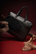 © Elena Kharichkina/Stocksy - Stylish leather bag displayed on natural wood branch