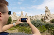 © Aleksei Toropov/Stocksy - Young man taking pictures of rocks in Cappadocia
