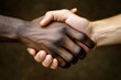© Andrii Savchuk - Handshake between two people symbolizing unity and cooperation on dark background