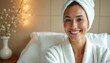 © Vadym - Smiling woman spa with warm lighting. Woman in bathrobe, towel on head enjoying relaxing moment. Self-care wellness, skin care treatment, calmness serenity atmosphere, joy, pampering, natural beauty.
