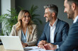 © Vadym - Smiling business people, colleagues, executives in suits at meeting. Teamwork, partnership, discussion, using laptop in modern office. Happy, positive atmosphere, corporate environment, success.