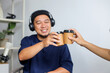 © Gatot - Two Men Record a Podcast and Enjoy Coffee Together, Sharing a Toast Mid-Conversation.
