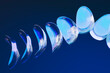 © Giada Canu/Stocksy - Minimalist abstract glass forms arranged in blue fluid spiral