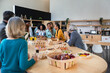 © VICTOR TORRES/Stocksy - Diverse group enjoying a casual office catering lunch gathering
