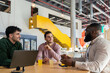 © VICTOR TORRES/Stocksy - Team collaboration in modern office with casual discussion