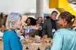© VICTOR TORRES/Stocksy - Social gathering with diverse professionals at lunch
