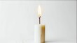 © your style - A single white candle burns brightly, melting wax is visible against a plain, neutral background.